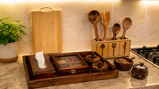 Indian kitchen countertop with wooden tray, spice boxes, chopping board, tissue box, utensil holder and warm lighting