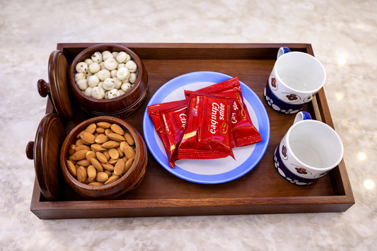 Wooden tray with brass inlay jar filled with dry fruits