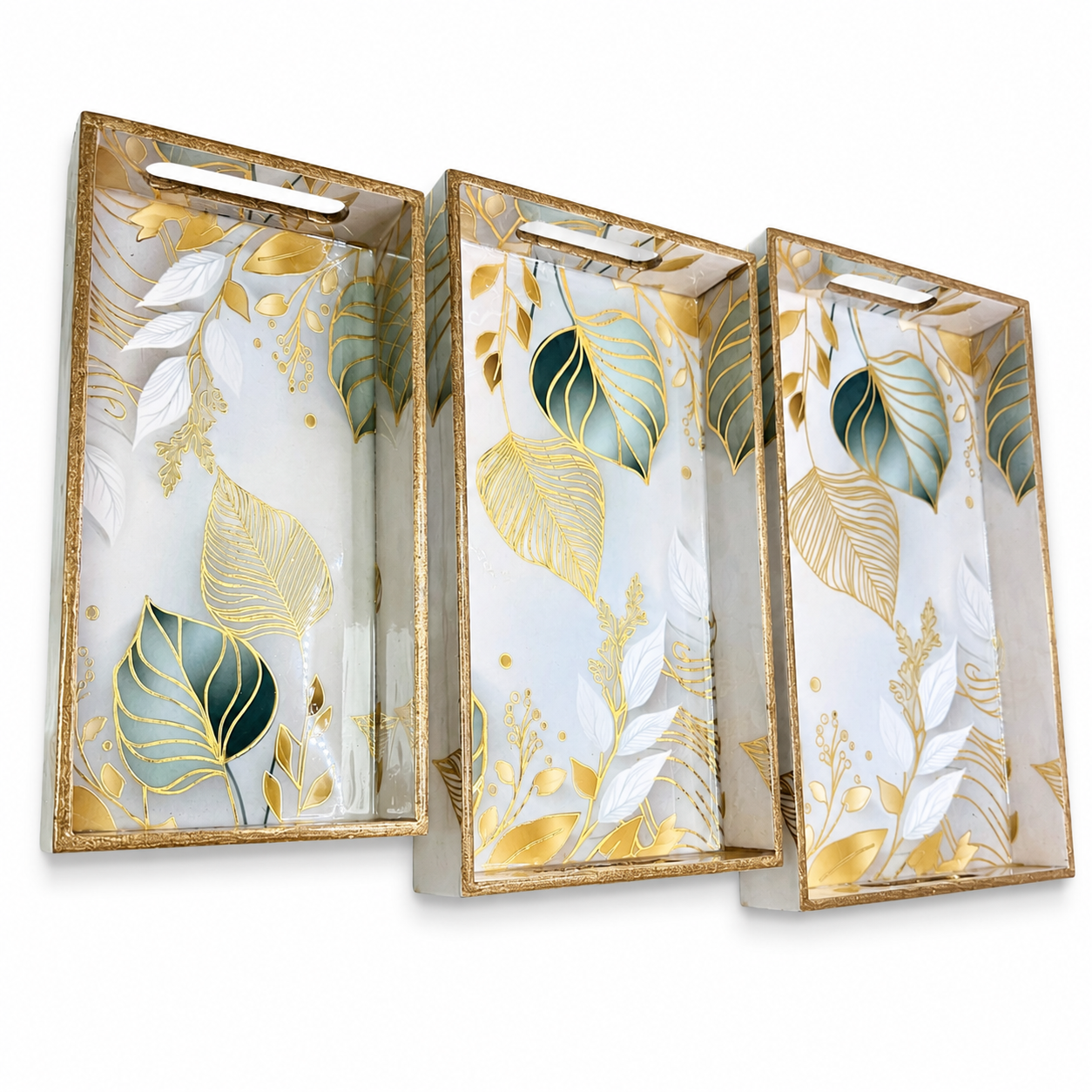 Three decorative trays with gold and green leaf patterns on a white background
