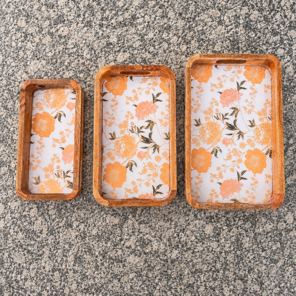 Floral waterproof mango wood enamel tray set of 3 with orange flower design on granite surface