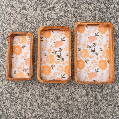 Floral waterproof mango wood enamel tray set of 3 with orange flower design on granite surface