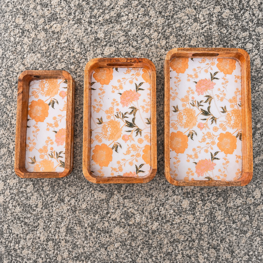 Floral waterproof mango wood enamel tray set of 3 with orange flower design on granite surface