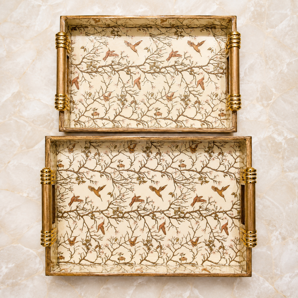 Top view of large and medium Ivory Songbird Branch enamel-coated serving trays displayed separately with elegant wooden handles