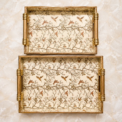 Top view of large and medium Ivory Songbird Branch enamel-coated serving trays displayed separately with elegant wooden handles