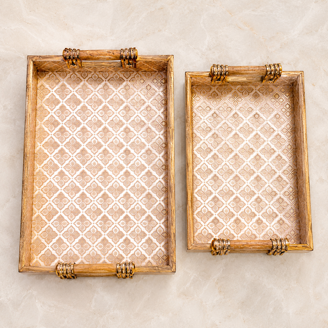 Top view of large and medium Royal Gold Trellis enamel-coated serving trays displayed side by side with elegant wooden handles