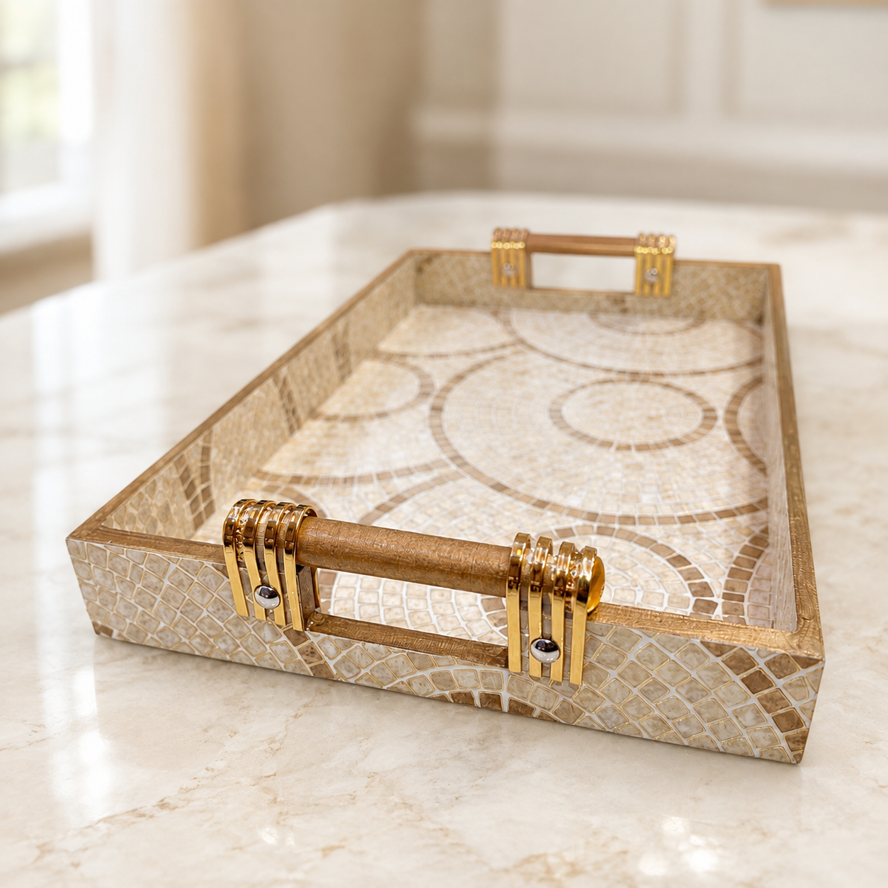 Angled close-up of Sandstone Mosaic Swirl enamel-coated serving tray with elegant wooden handles and beige circular mosaic design
