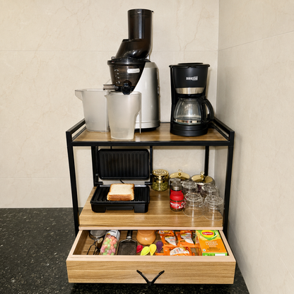 Sinecraft multipurpose kitchen rack used as a breakfast station with cold-press juicer, coffee maker, open sandwich toaster, cups and spacious storage drawer.