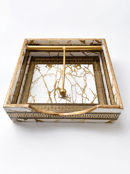 White marble-design open tissue holder with gold Greek-key detailing and metal tissue bar.